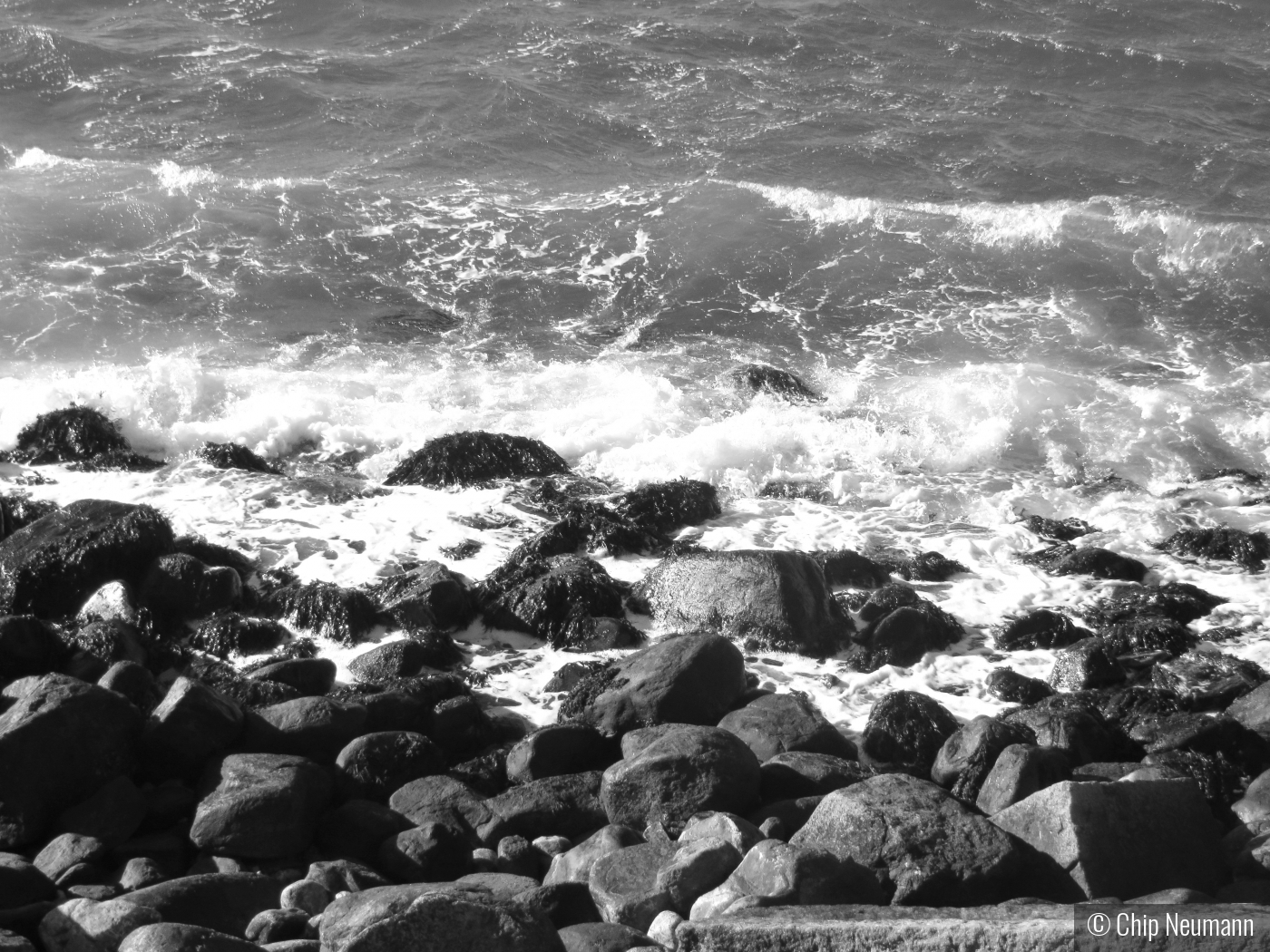 Waves breaking on the rocks on a cold day in January by Chip Neumann